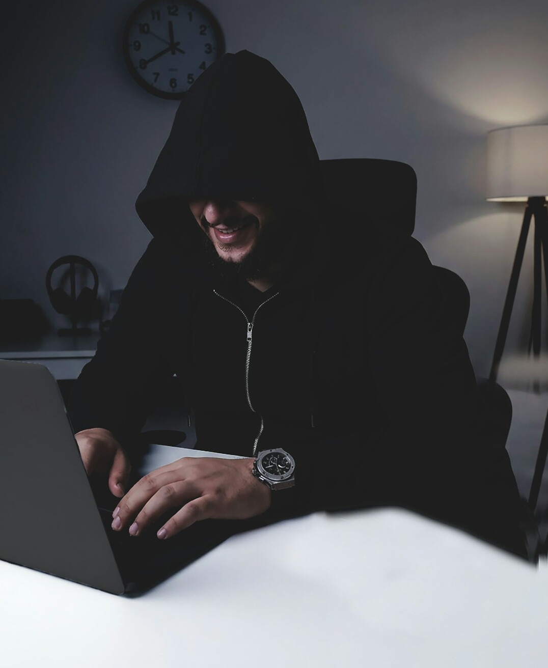 programmer coding on laptop at desk