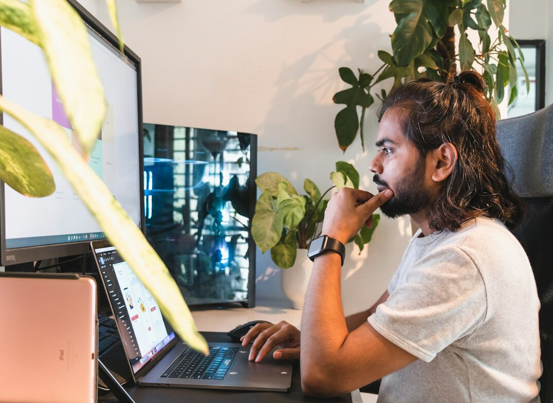man working remotely on laptop