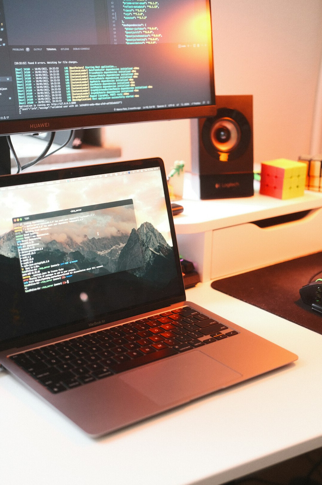 programmer coding on laptop at desk